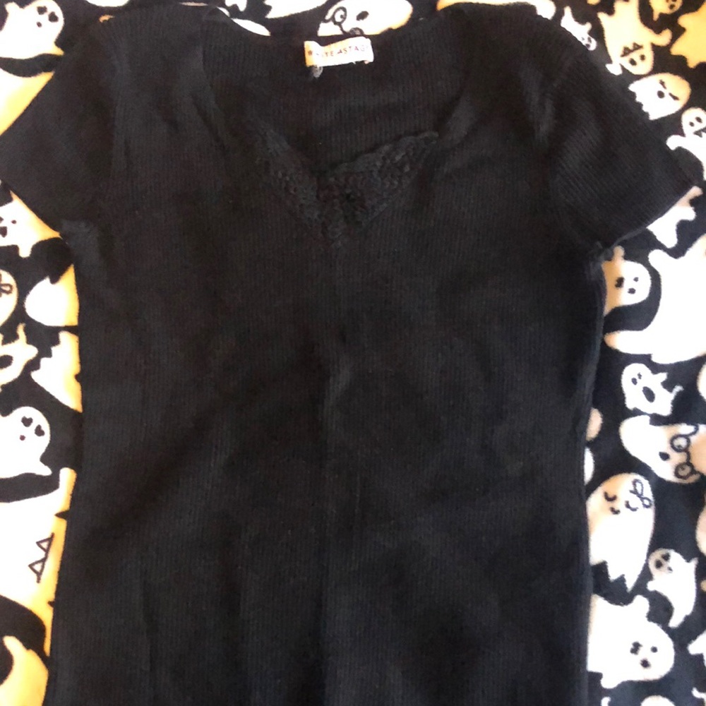 A black shirt with lacy sort of V-neck